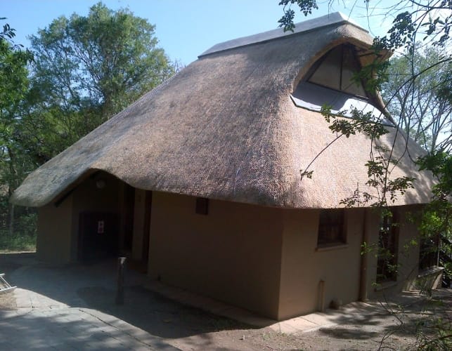 The completed thatched roof and dormer window on the finished lodge.